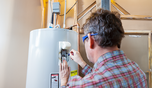 An image displaying the technician repairing a furnace.